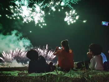 Rear view of people at illuminated park