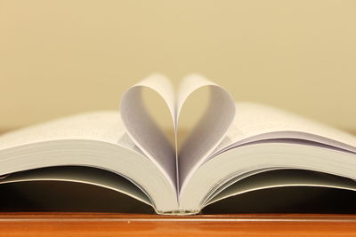 Close-up of heart shape made from book pages