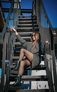 Low angle view of woman sitting on staircase