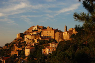 Buildings in town against sky