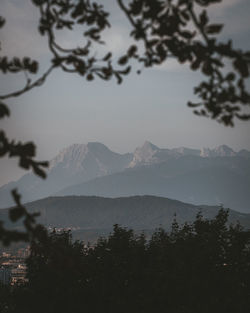 Scenic view of mountain range against cloudy sky