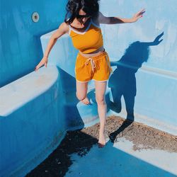 Full length of woman standing in swimming pool