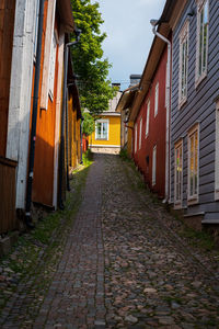 Narrow alley amidst houses in city