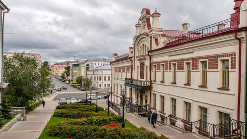 Street amidst buildings in city against sky