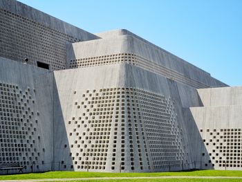 Low angle view of modern buildings against clear blue sky