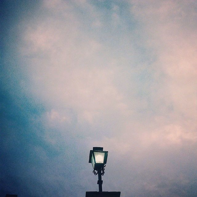 low angle view, sky, cloud - sky, lighting equipment, street light, cloudy, cloud, silhouette, built structure, dusk, outdoors, nature, no people, high section, weather, architecture, copy space, day, overcast, beauty in nature