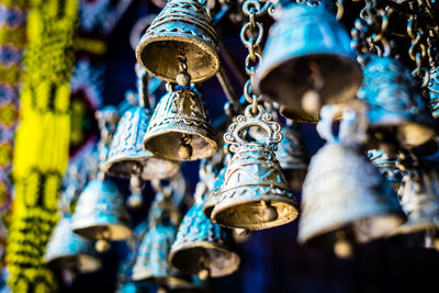 Low angle view of bells hanging for sale in market