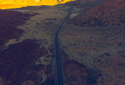 High angle view of road amidst land against sky