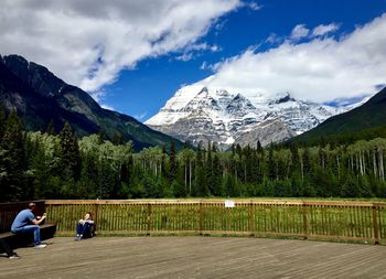 People on snowcapped mountain against sky