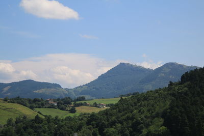 Scenic view of trees and mountains against sky