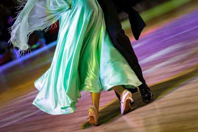 Low section of people dancing on floor