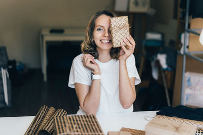 Portrait of a smiling young woman holding ice cream