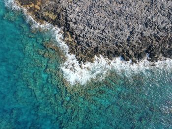 Drone shot of rocky coast line in crete, near chania, stravos beach, greece