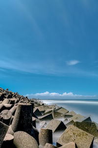 Rocks on beach against sky