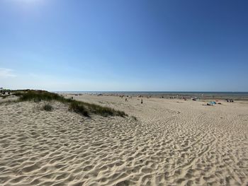 Scenic view of beach against clear blue sky