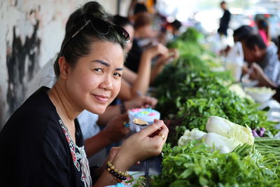 Portrait of woman eating street food