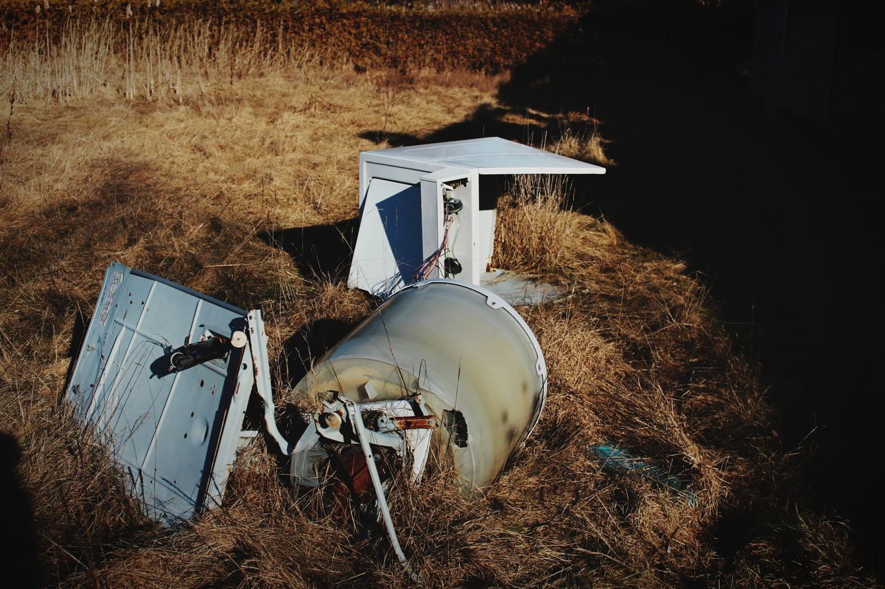 field, land, transportation, nature, mode of transportation, land vehicle, no people, day, plant, abandoned, stationary, outdoors, environment, grass, hay, farm, architecture, motor vehicle, landscape, agriculture