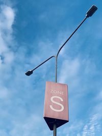 Low angle view of road sign against sky