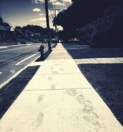 Shadow of man crossing road