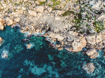 High angle view of rock formation in sea