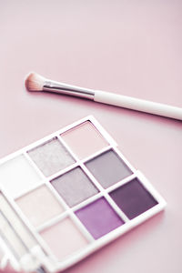 High angle view of make-up brushes against white background