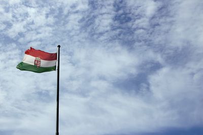 Low angle view of hungarian flag against sky