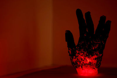 Close-up of hand on glass table