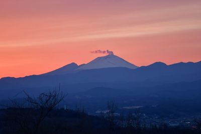 Scenic view of silhouette mountains against sky during sunset