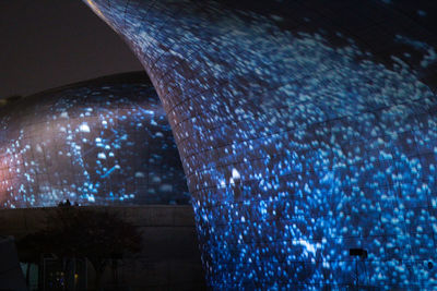 Low angle view of illuminated building against sky at night