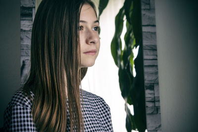 Portrait of beautiful young woman looking away