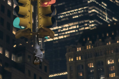 Low angle view of illuminated lights hanging from ceiling at night