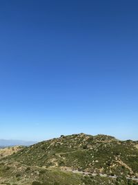 Scenic view of mountains against clear blue sky