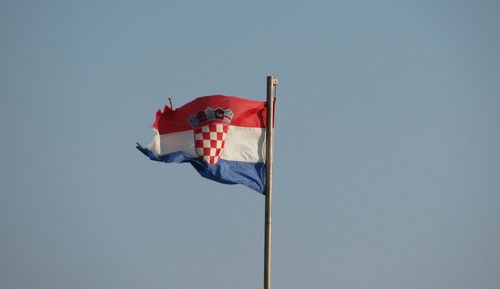 Low angle view of croatian flag waving against clear sky