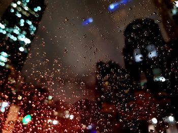 Close-up of wet glass window in rainy season