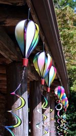 Multi colored balloon lanterns hanging on wood