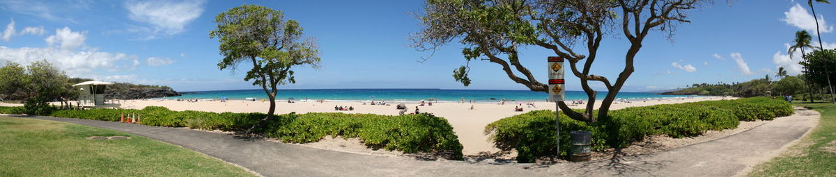 Scenic view of beach against blue sky