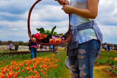 Midsection of woman holding flowers