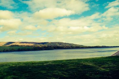 Scenic view of landscape against cloudy sky