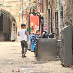 Rear view of people standing on street