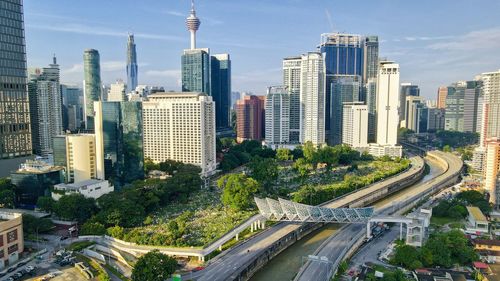 High angle view of road amidst buildings in city against sky