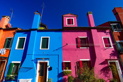 Low angle view of buildings against blue sky