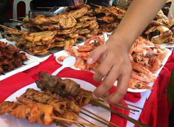 Midsection of people holding food