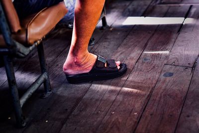 Low section of man on wooden floor