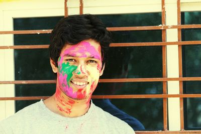 Portrait of young man with paint on face during holi