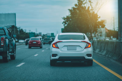 Traffic on road at sunset