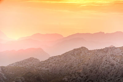 Scenic view of mountains against sky during sunset