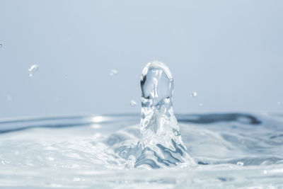 Close-up of splashing water against blue background