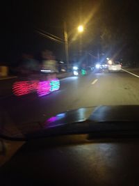 Close-up of illuminated car on road at night