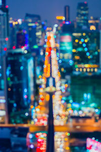 Defocused image of illuminated city at night