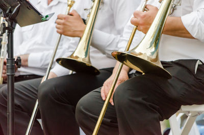 Midsection of people playing musical instruments